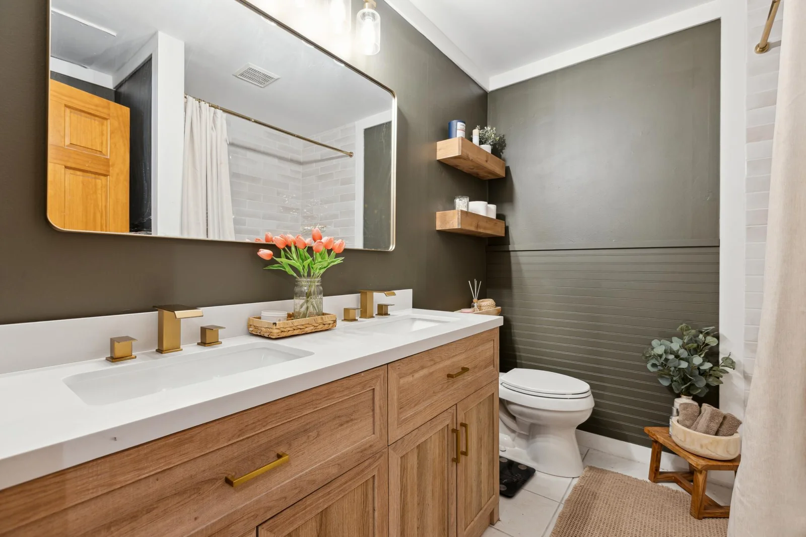 Renovated main bathroom with new dual vanity, steel tub, mirror, paint, etc.