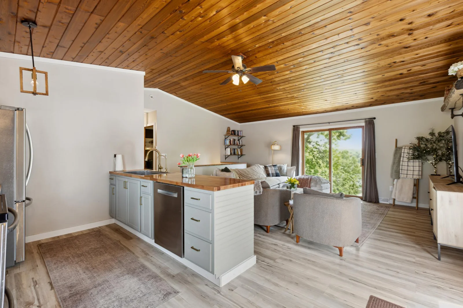 New kitchen island with butcher block counter tops, plus views of the lake through the sliding door window.