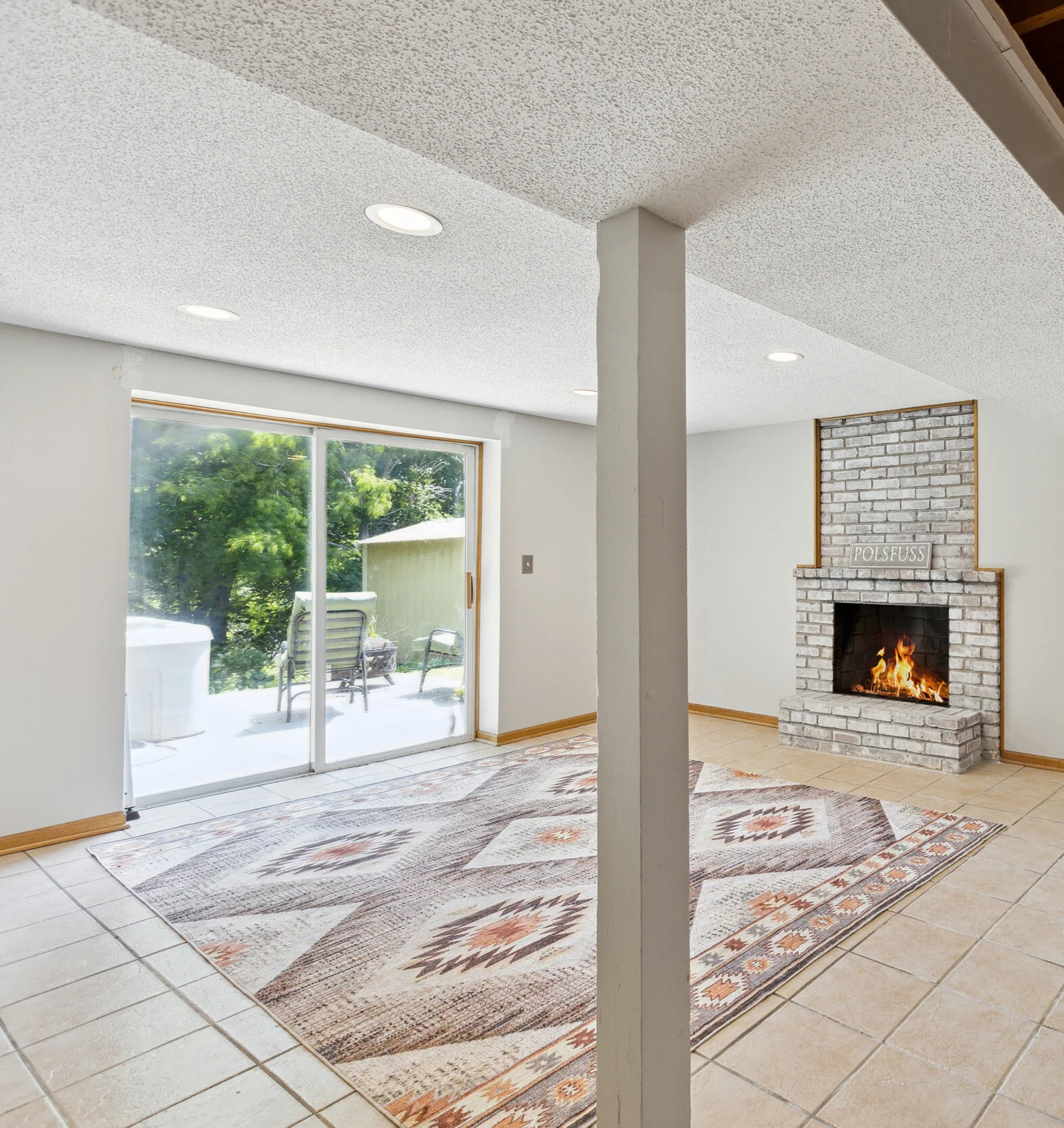 basement walkout with patio and hot tub