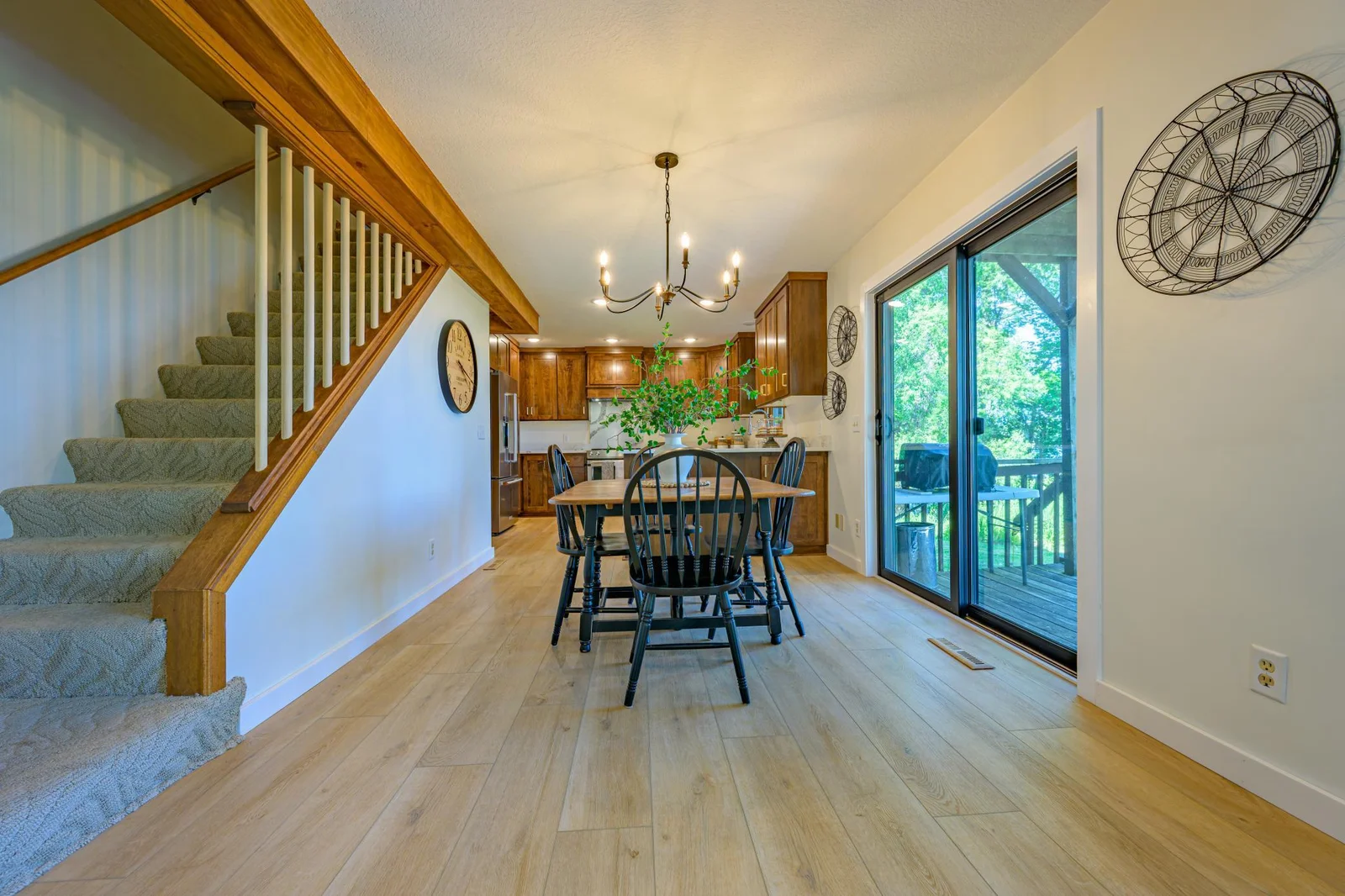 The dining area features LVP flooring and a patio door that heads out to the deck.