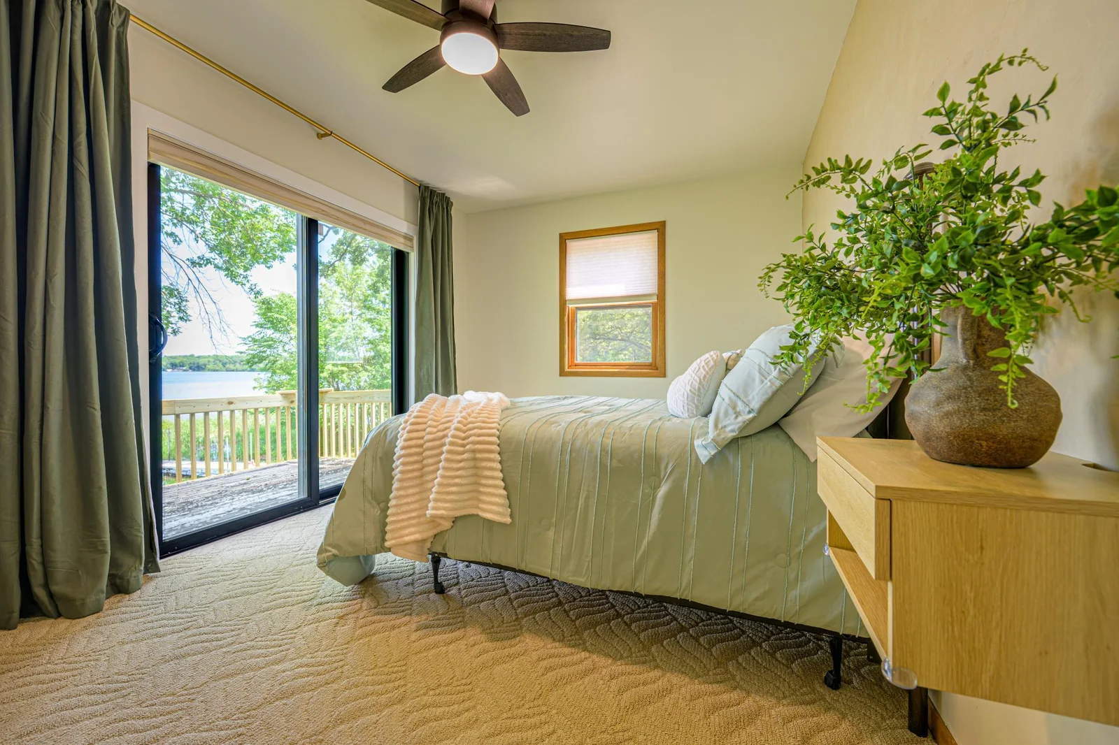 Upstairs, the primary bedroom features a patio door to a private balcony that overlooks the lake.