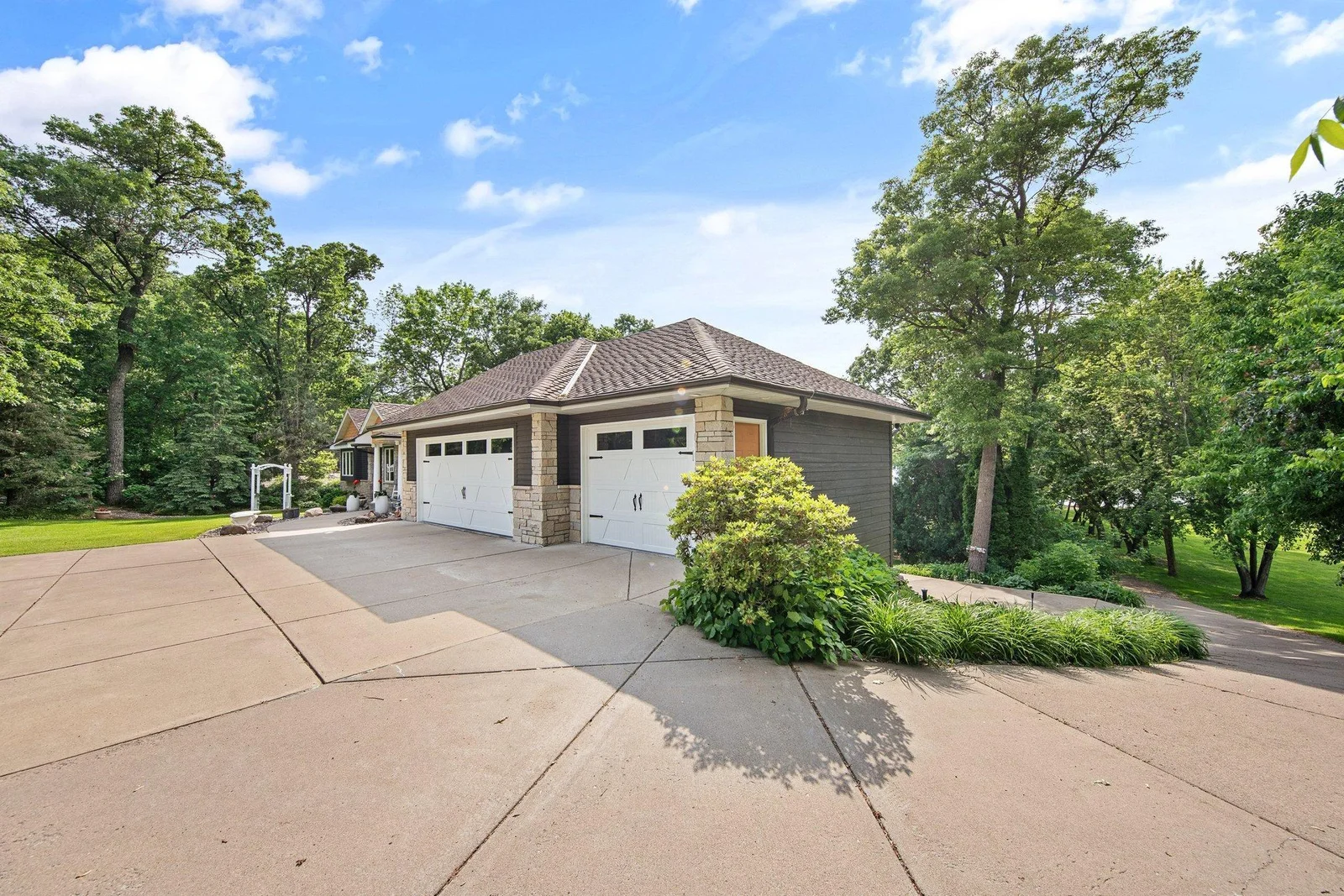 3 car attached garage with a full concrete driveway. Additional driveway leading to the lower 2 car garage perfect for a boat and water toy storage!
