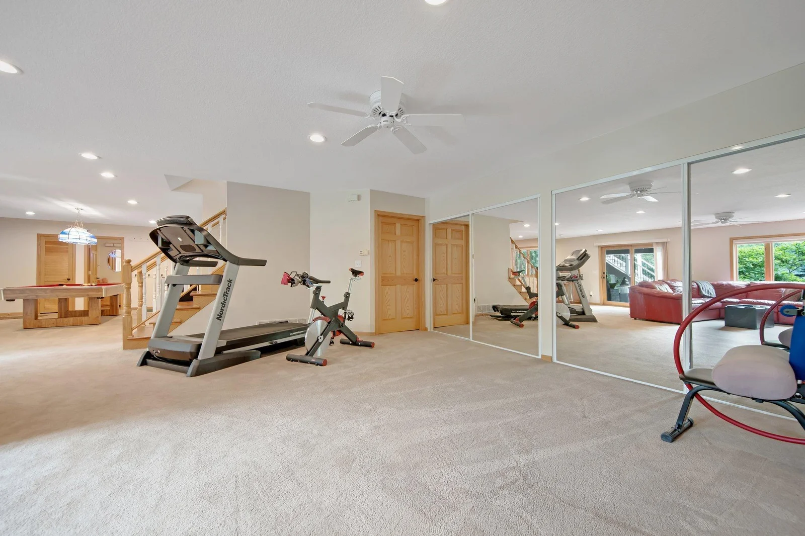 So much space in the lower level! Large storage behind the mirrors and a full storage room under the stairs.