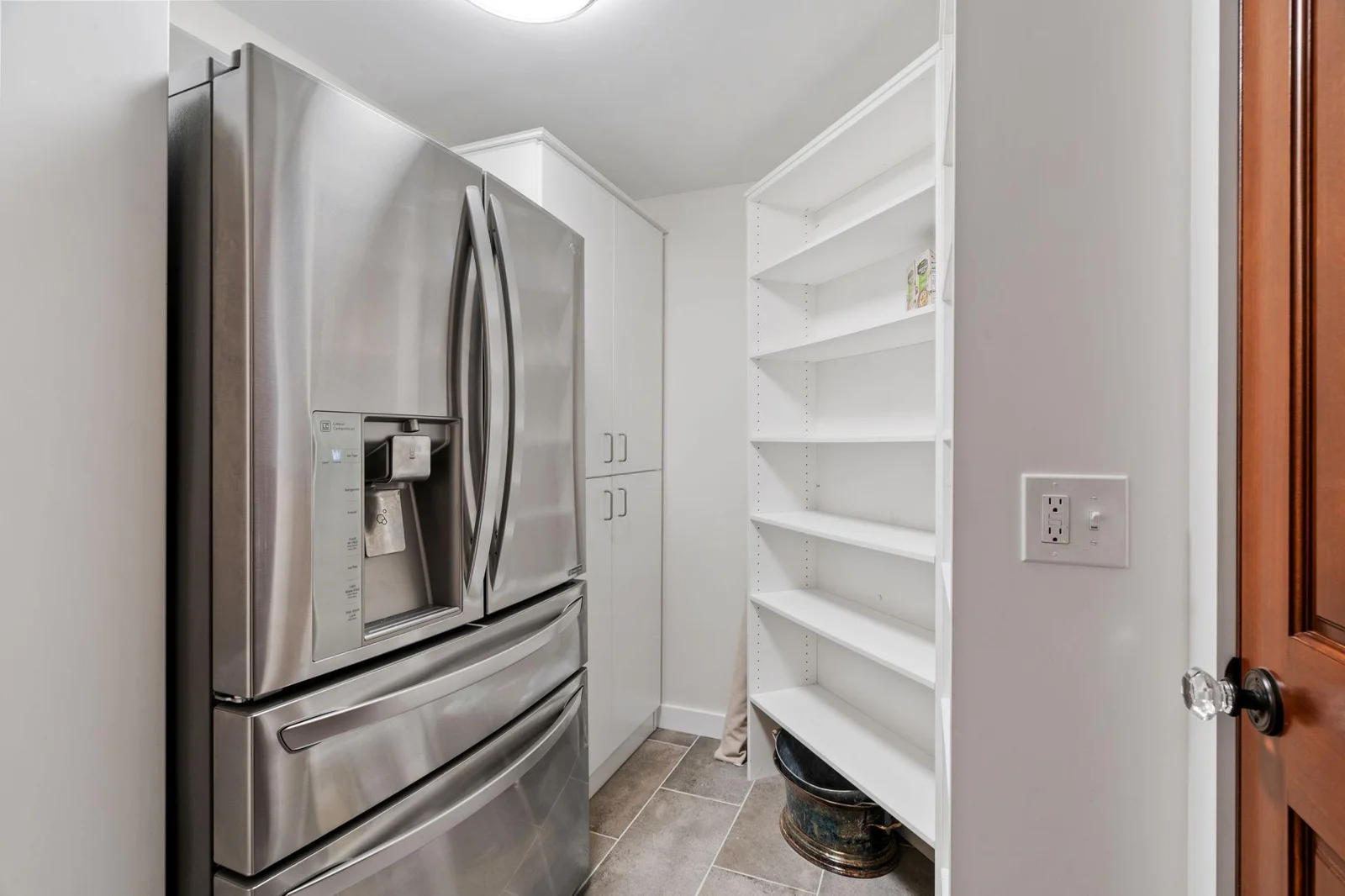 Plenty of storage space in the lower level including this extra walk-in storage room with extra refrigerator.