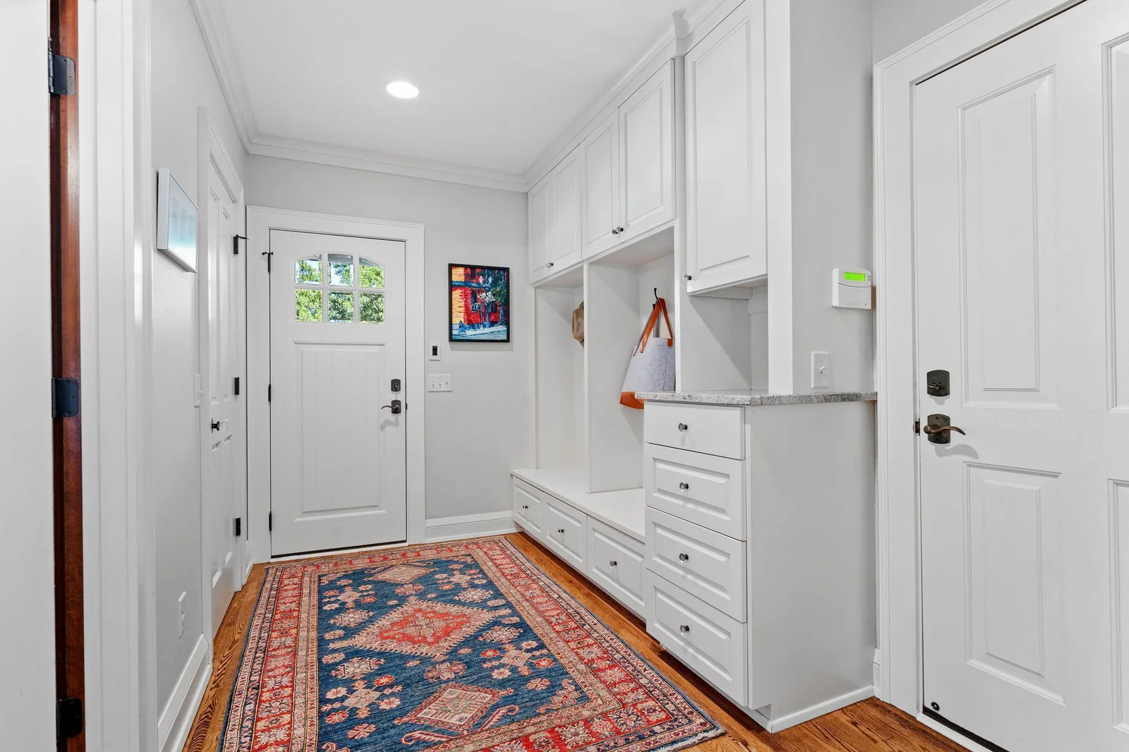 Large mudroom and powder bathroom are located right off the pool entrance to make summer days a breeze to access the inside and outdoors.