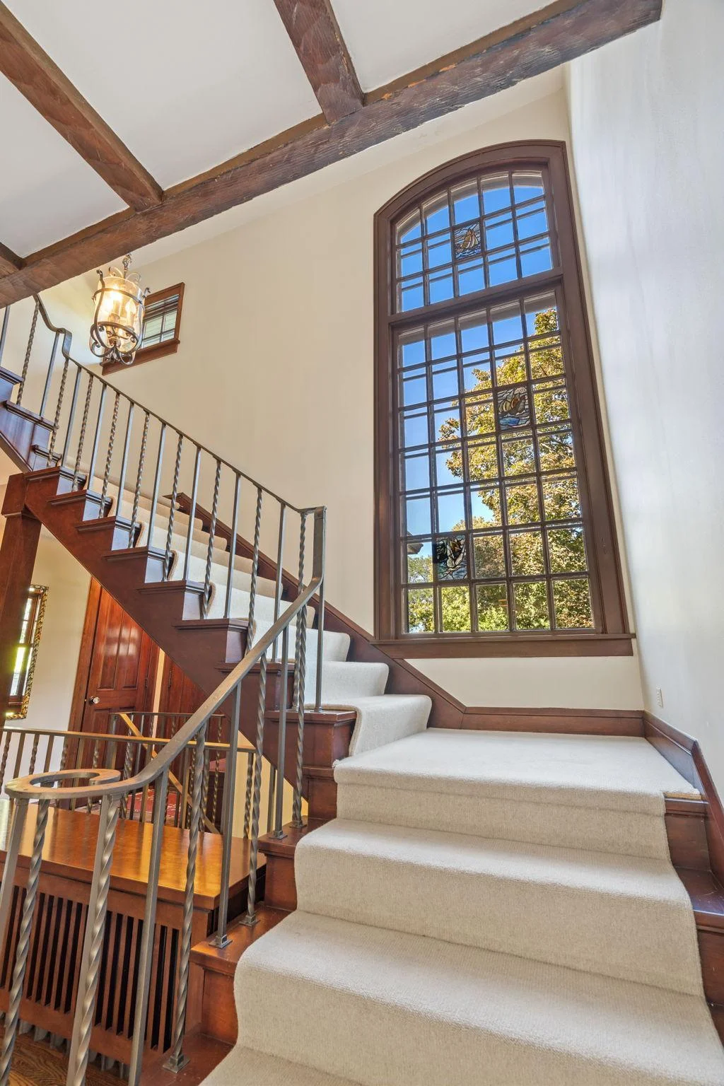 Dramatic staircase windows provide old-world charm and character.