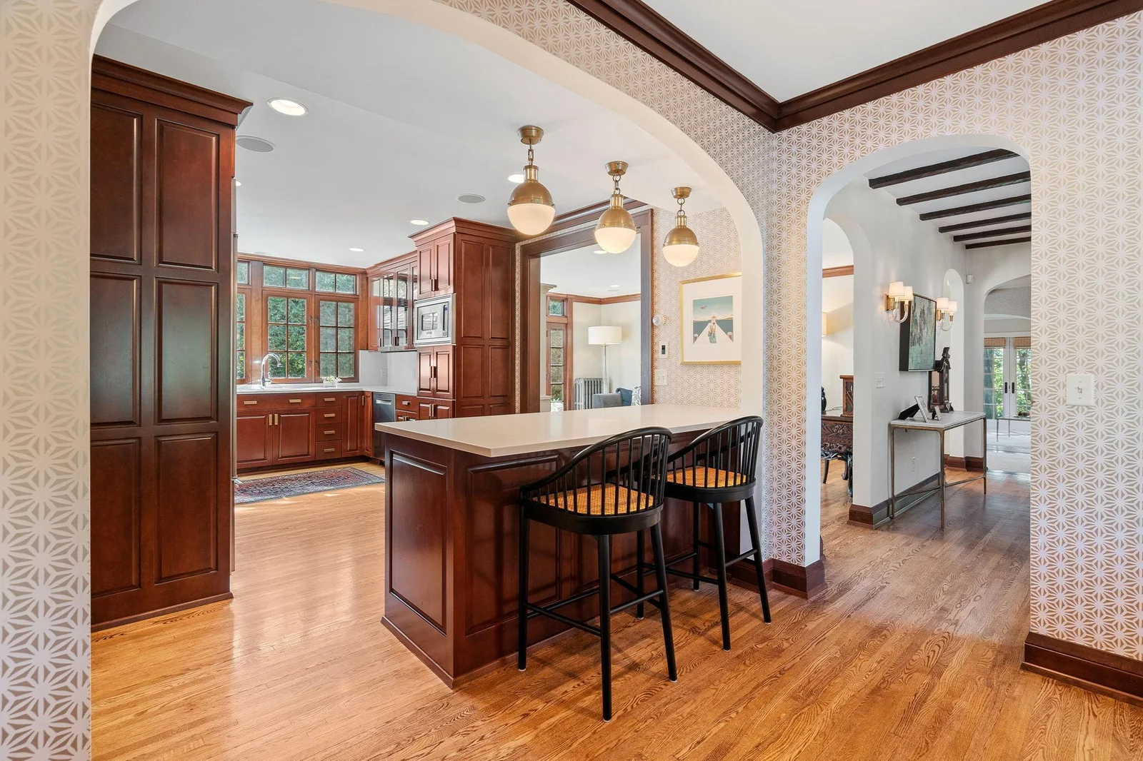The gourmet kitchen flows elegantly into the dedicated dining space and one of the large living rooms.