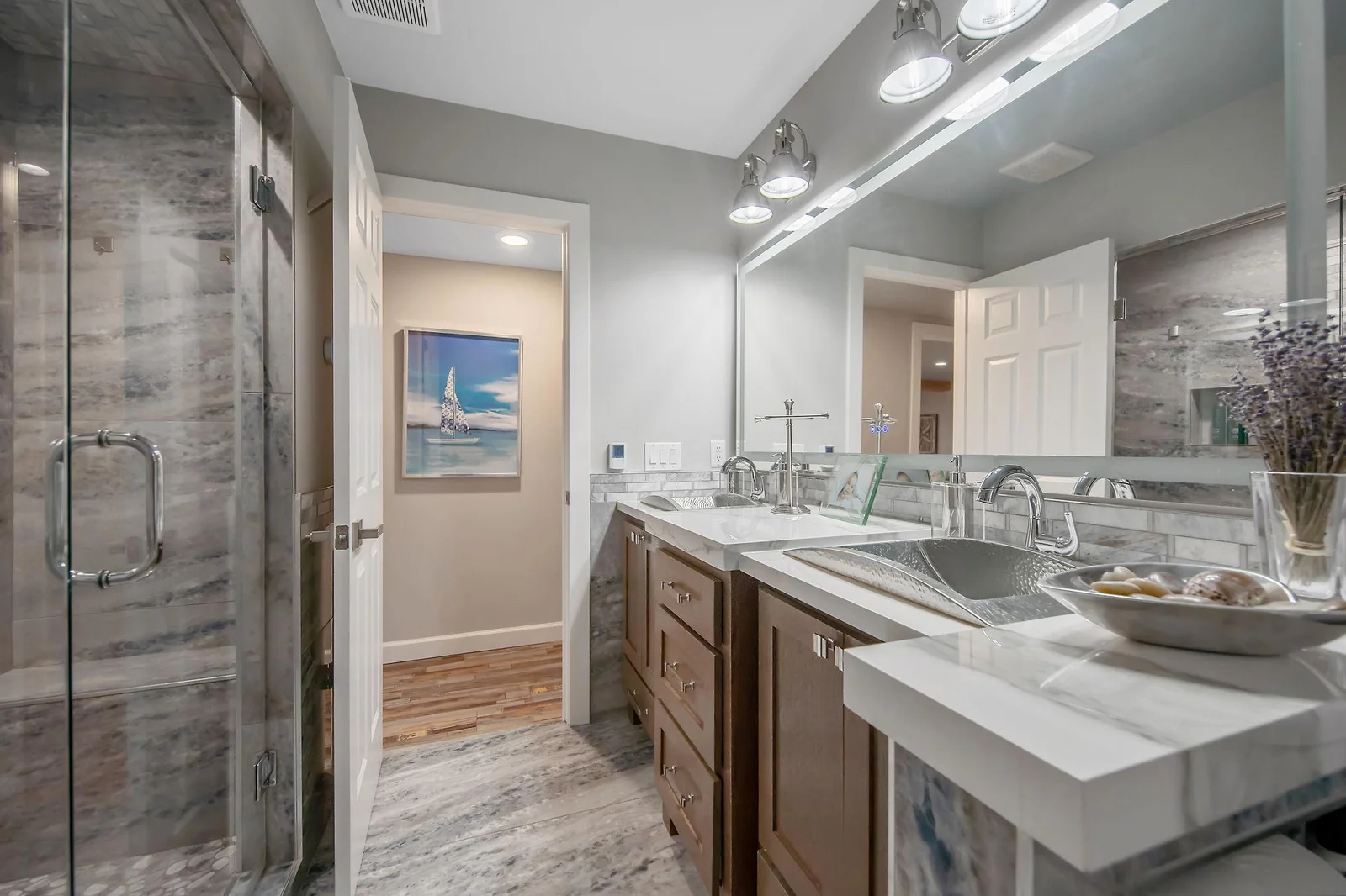 High end hammered silver sinks and Italian porcelain counters in the lower level 3/4 bath.  View # 2.