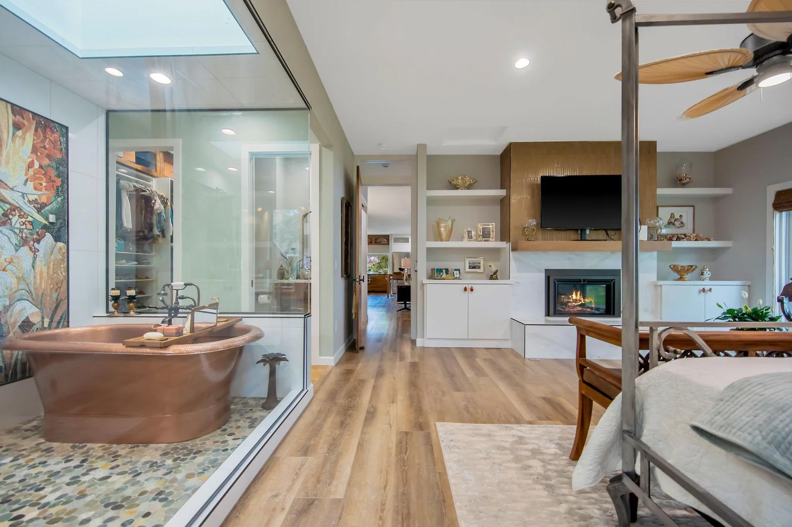 Owner's suite - a true retreat from a long day featuring marble surround fireplace surrounded by built ins, Spa room with a copper tub in which you can turn on the steam shower, fill up the tub w/bubbles, lay back &  enjoy sunset views.