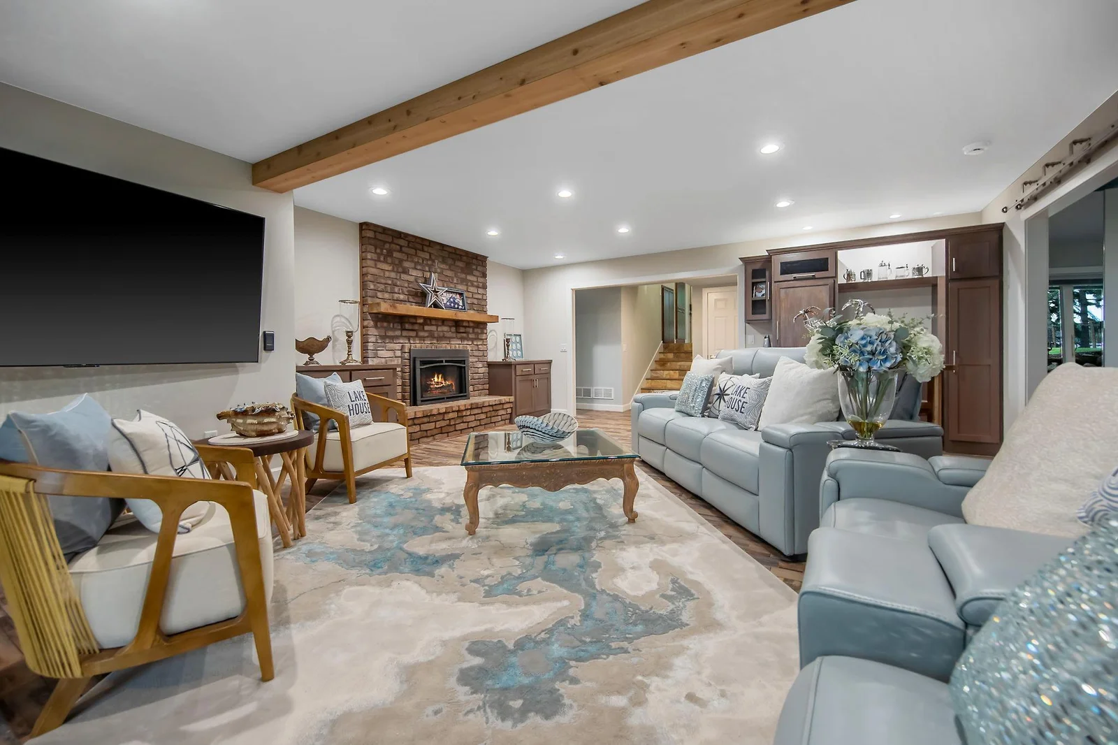 Huge family room with sliding walkout doors leading to the 4 season porch, brick surround fireplace and wet bar.