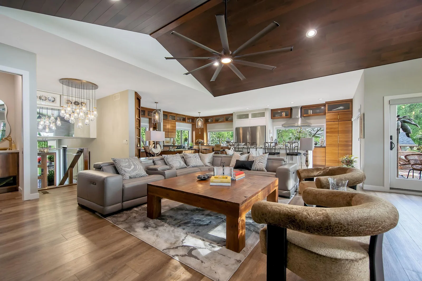 Vaulted open-concept Great Room highlighted by a huge ceiling fan and Restoration Hardware light fixtures.