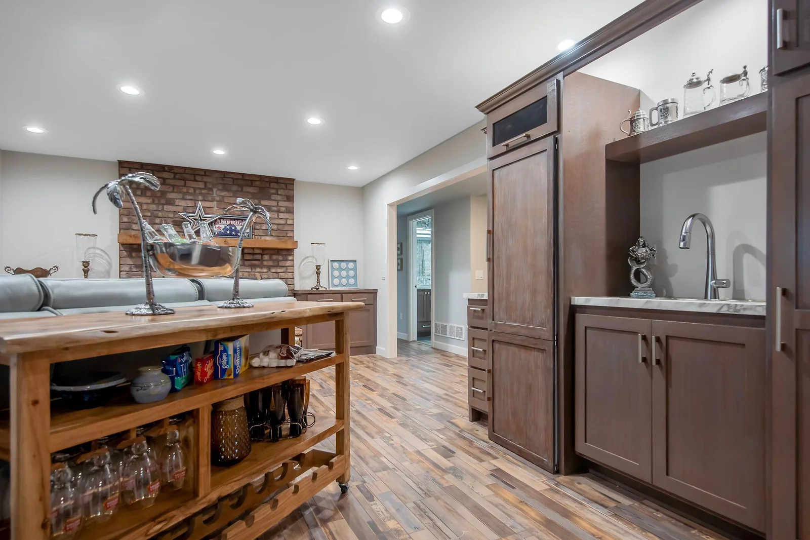 Lower level wet bar with refrigerator. Don't forget to check out the beautiful hammered sink with sea shell detail.