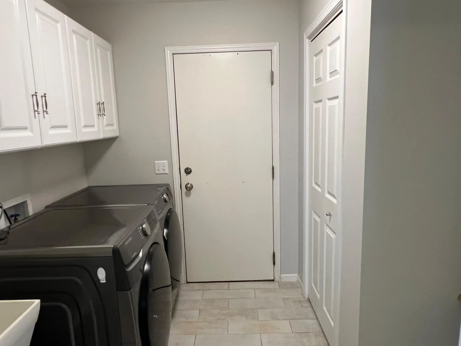 THE MUDROOM/LAUNDRY ROOM.  THE DOOR LEADS TO THE ATTACHED GARAGE.