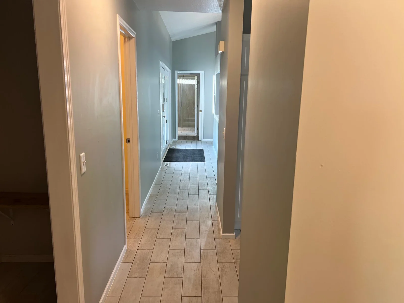 VIEW FROM THE OPPOSITE END OF THE HALLWAY LOOKING TOWARDS THE PRIMARY SUITE