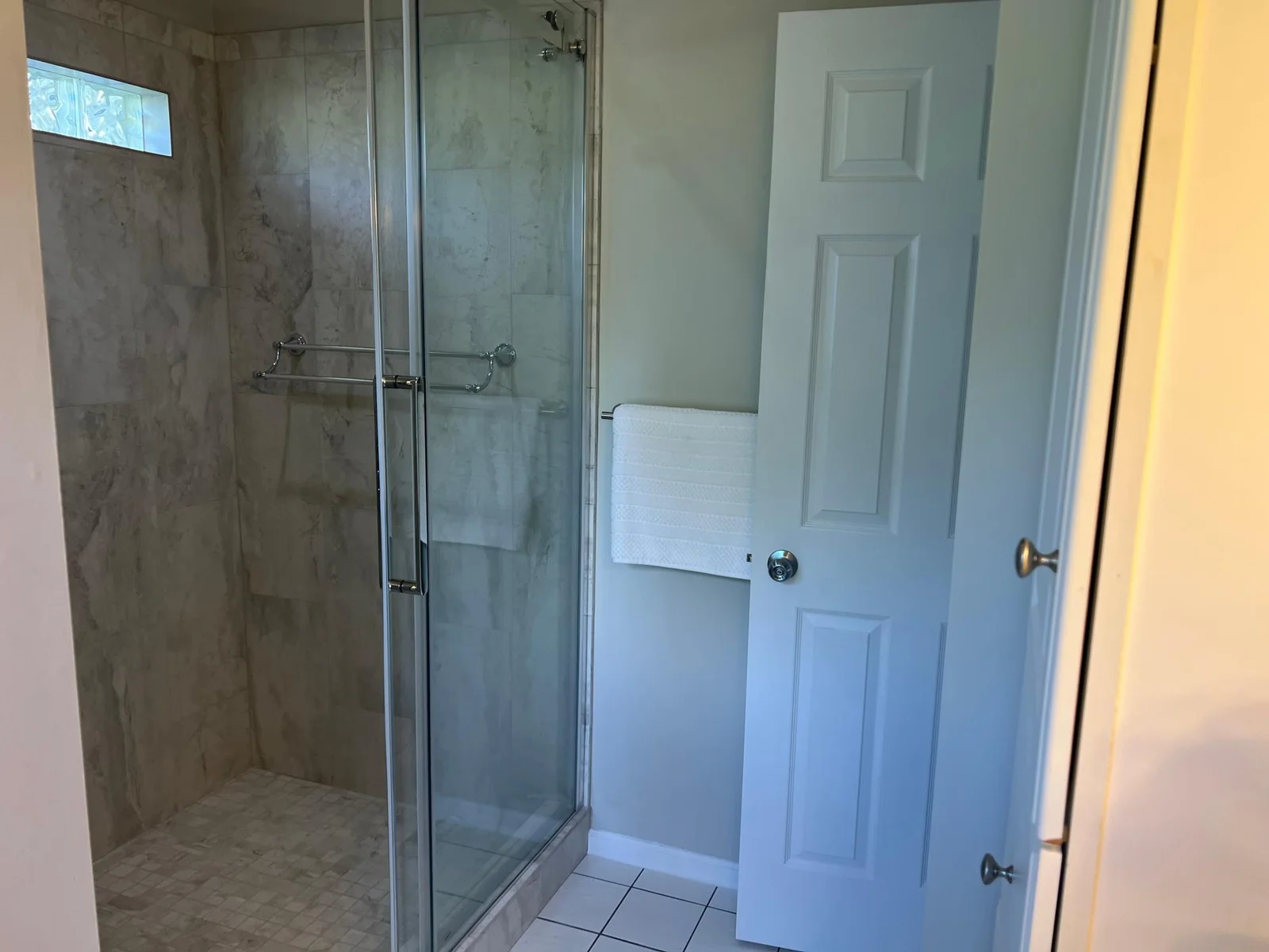 THE BACK WALL OF THE SHOWER.