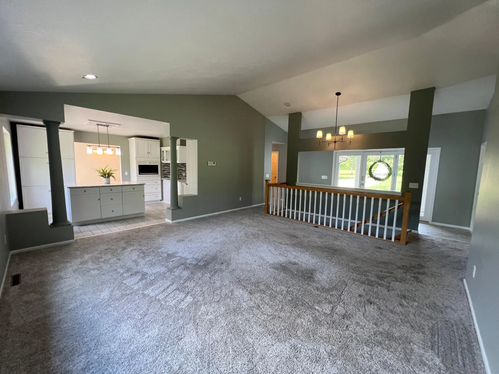 LOOKING TO THE KITCHEN & ENTRY AREA FROM THE NE CORNER OF THE LIVING ROOM.