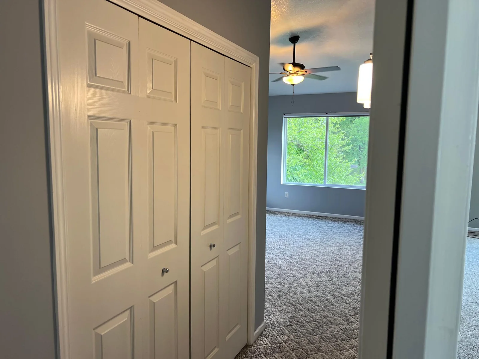 THE HALL LEADING FROM THE BATH TO THE BEDROOM.  THE CLOSET AT THE LEFT HAS FLOOR TO CEILING SHELVING.