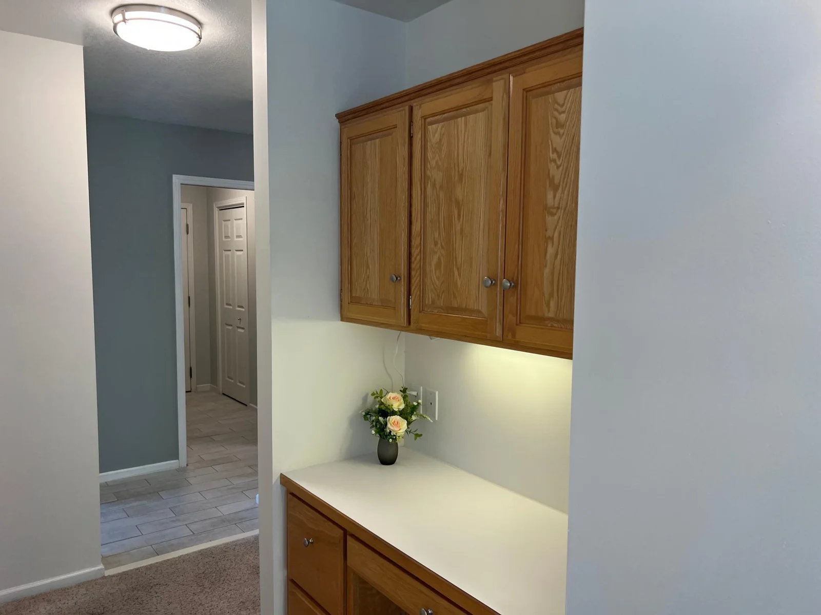 THIS IS THE PLANNING STATION JUST OFF THE DINING ROOM WHERE YOU CAN DO MENU PLANNING, KEEP COOKBOOKS & HOUSEHOLD RECORDS.  THE LAUNDRY/MUDROOM ROOM IS JUST BEYOND THE HALL; AS IS THE DOOR TO THE GARAGE.