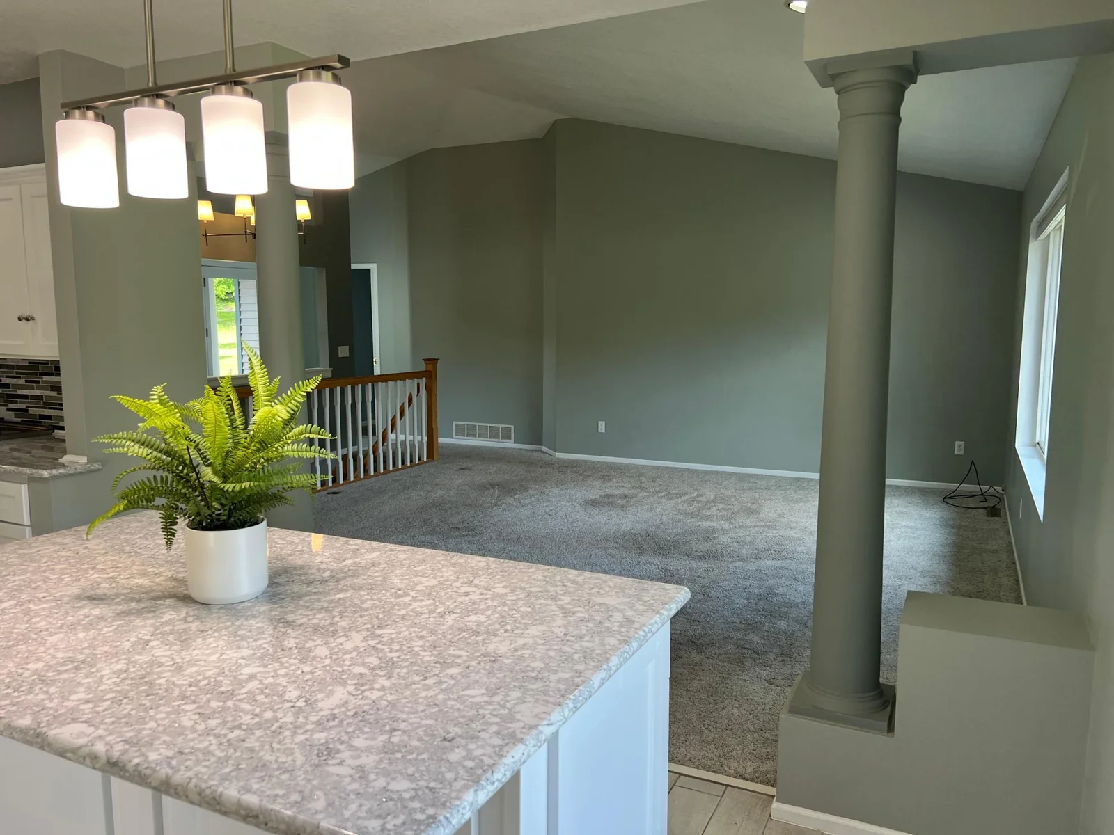 LOOKING BACK FROM THE KITCHEN INTO THE LIVING ROOM.