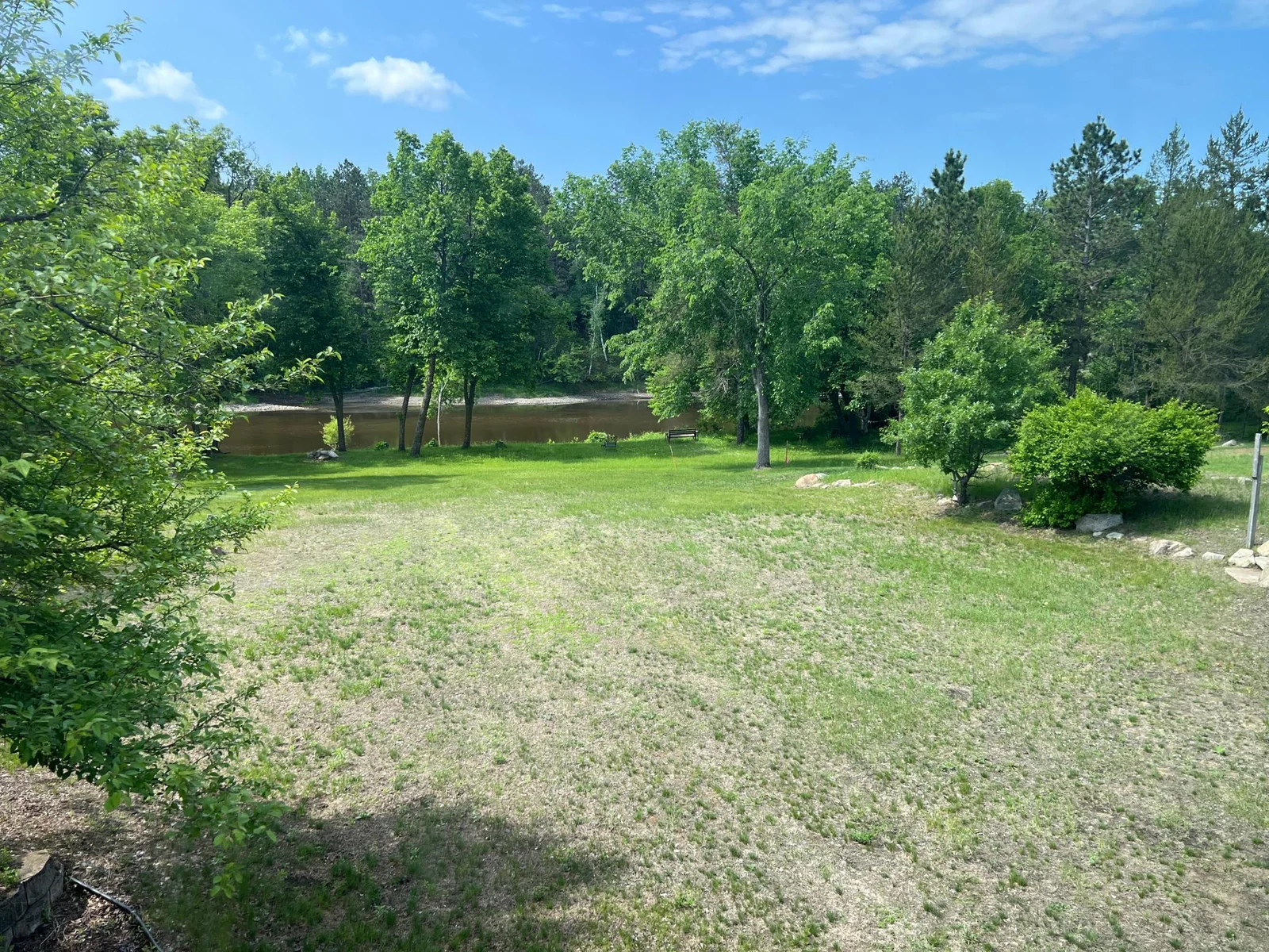 THE VIEW TO THE RIVER FROM THE BACK ELEVATION OF THE HOME.  THE BACK YARD IS BIG, WIDE, LEVEL AND PERFECT FOR GATHERINGS AND YARD GAMES !