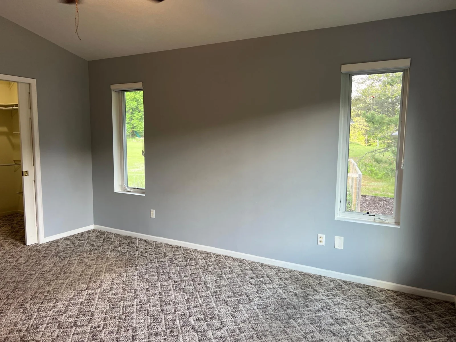THE PRIMARY BEDROOM ENJOYS AN ABUNDANCE OF NATURAL LIGHT WITH TWO WINDOWS ON THE NORTH WALL.........