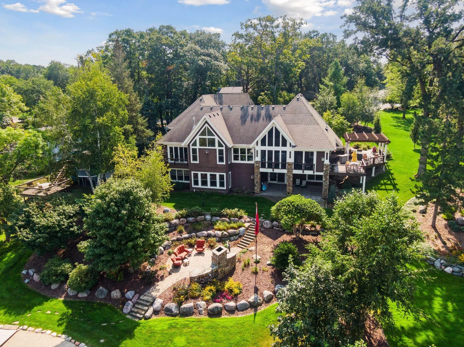 Professionally landscaped by By the Yard - a - this home is a showstopper from the lake.