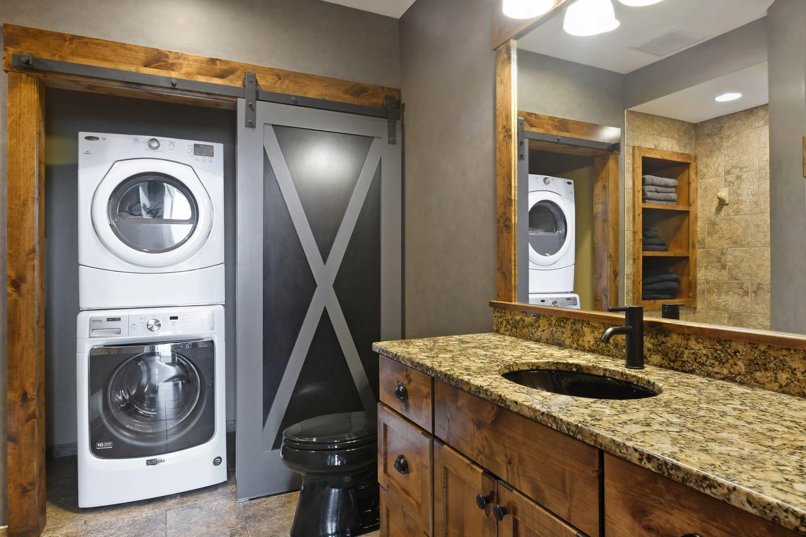 The washer and dryer is conveniently located behind barn doors.