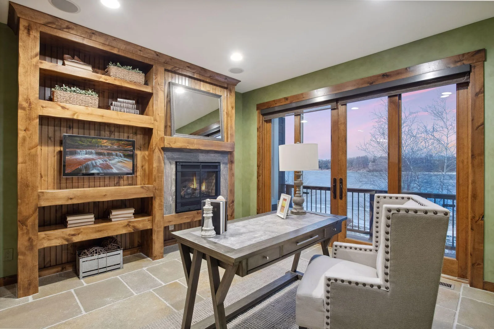 Tucked behind French doors, you'll find the main floor office with gas fireplace and a private balcony with lake views. There is also built-in bookshelves and entertainment center wall cabinet with shelves and outlets for hiding/charging cell phones