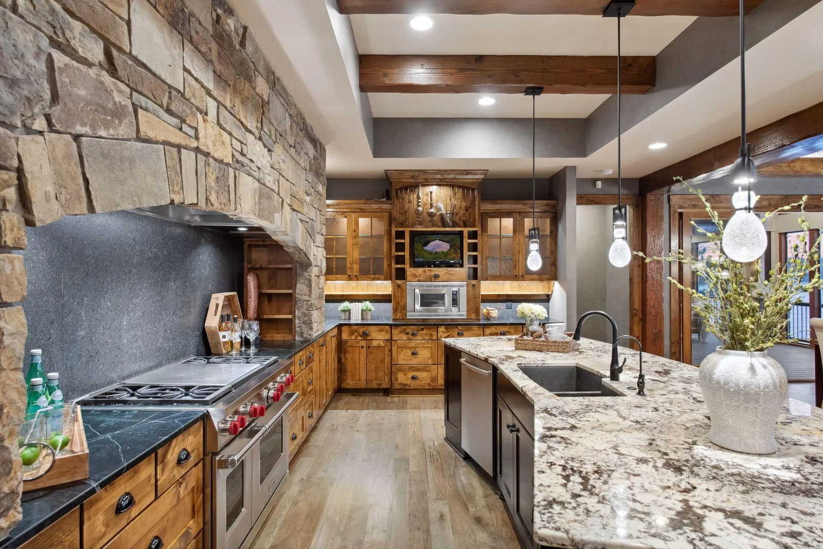 Well equipped with a Wolf gas range with hidden spice shelving, Bosch dishwasher and Thermador Refrigerator