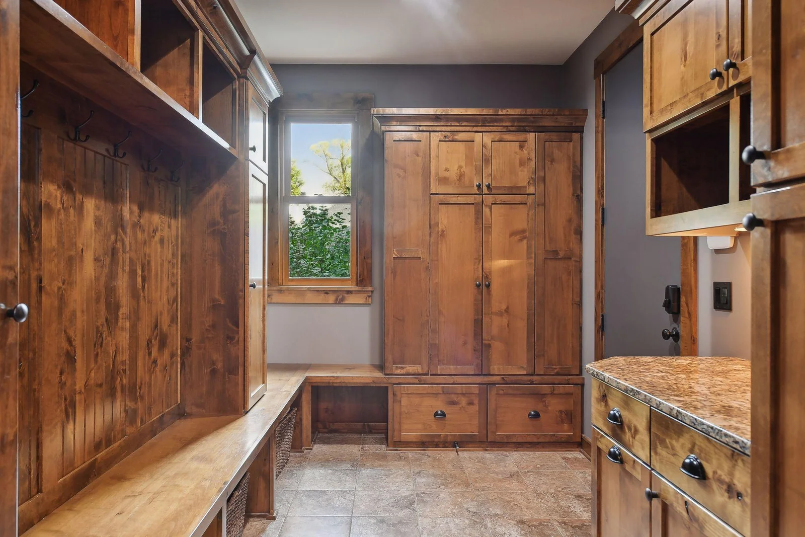 The tiled mudroom offers lockers, a sorting desk and boot bench