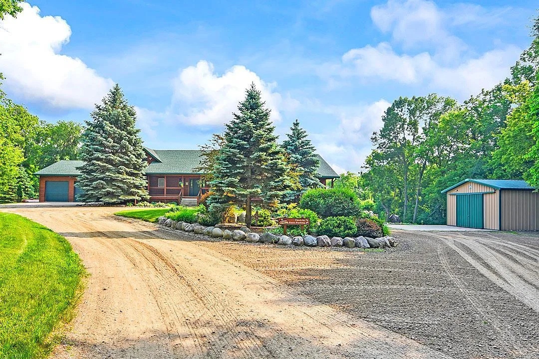 7458 39th Ave, Garfield, MN  The circle drive is very welcoming, the park like center garden boast perennials and pines for year-round beauty.