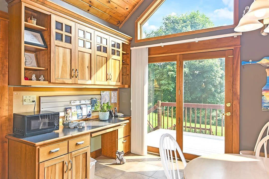 7458 39th Ave NW, Garfield, MN Beautiful cabinetry created locally by Swedberg's, patio door opens to the multi tiered deck overlooking the yard.