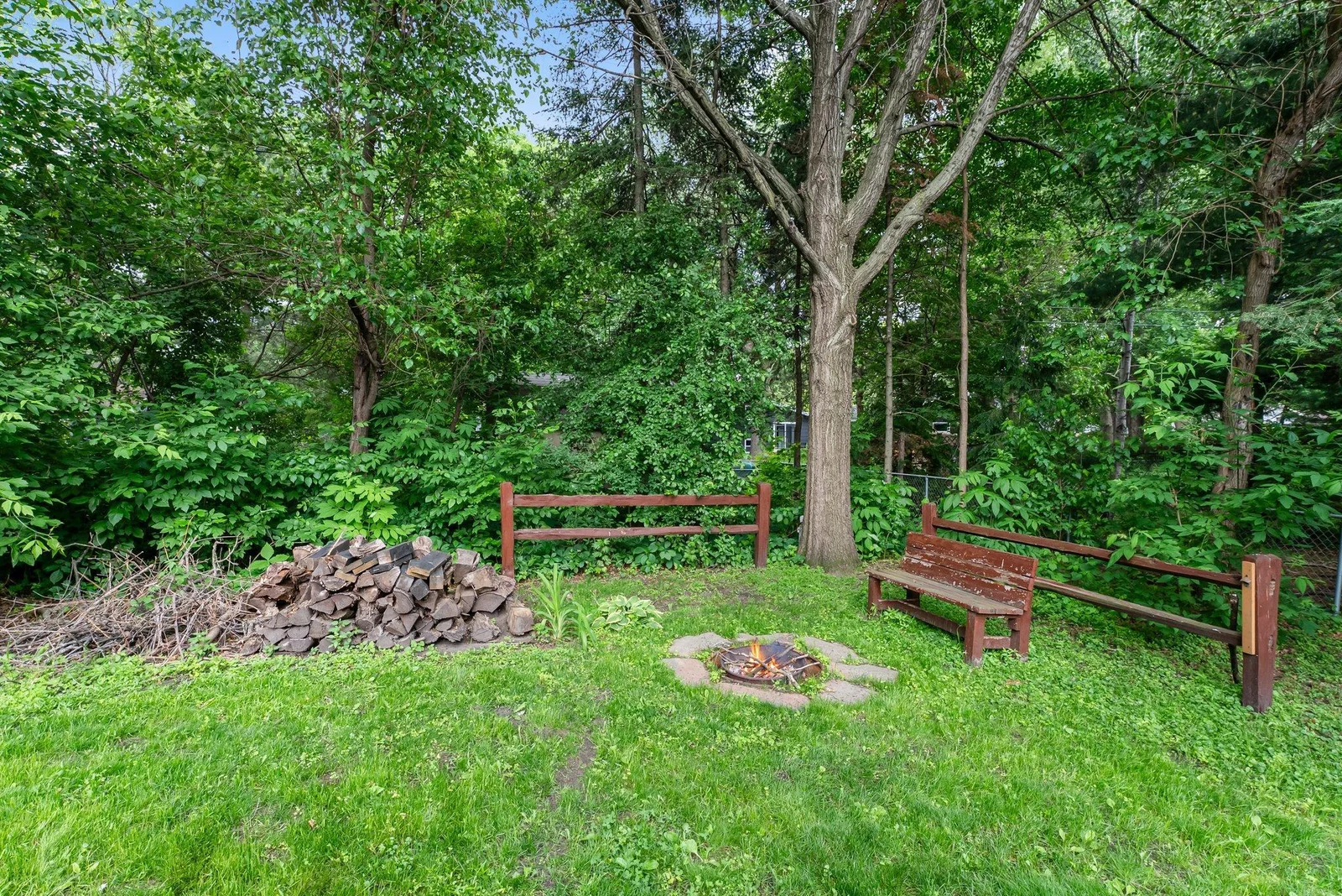 Rustic campfire area at back corner of lot