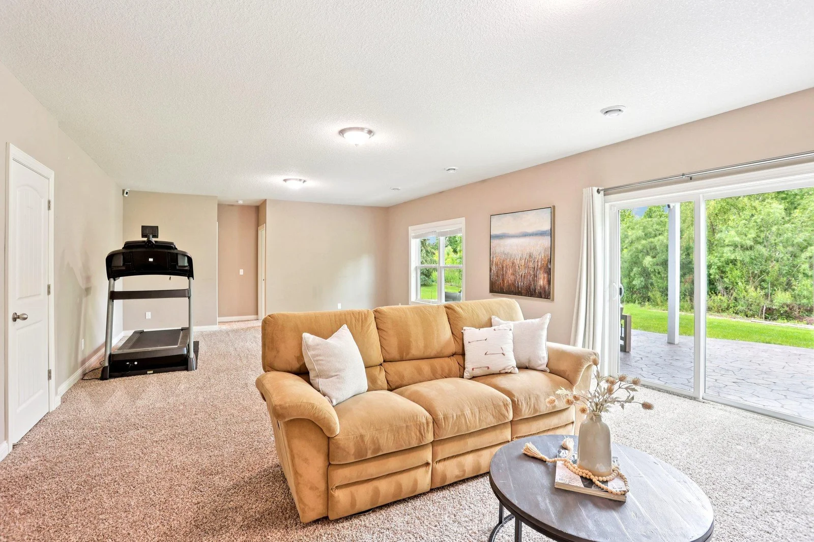 Walks out to private stamped concrete patio and serene backyard.