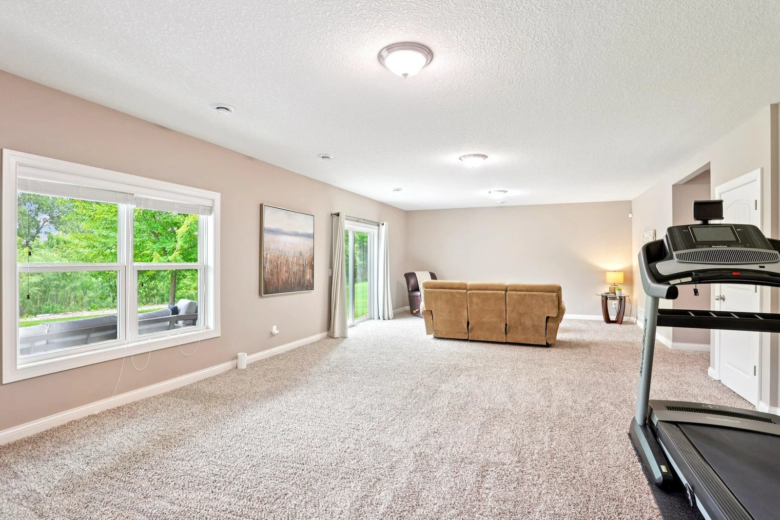 Lower level features an additional bedroom and inviting living space perfect for guests or entertaining.
