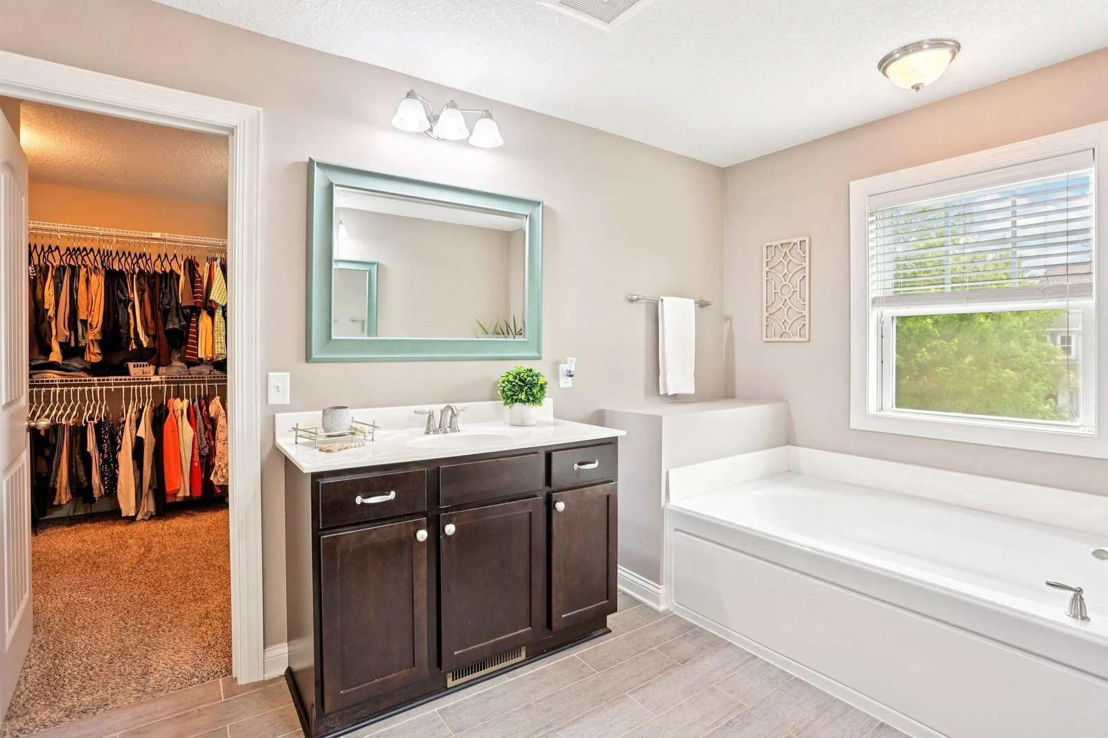 Spa-like ensuite bath with soaking tub and walk-in shower.