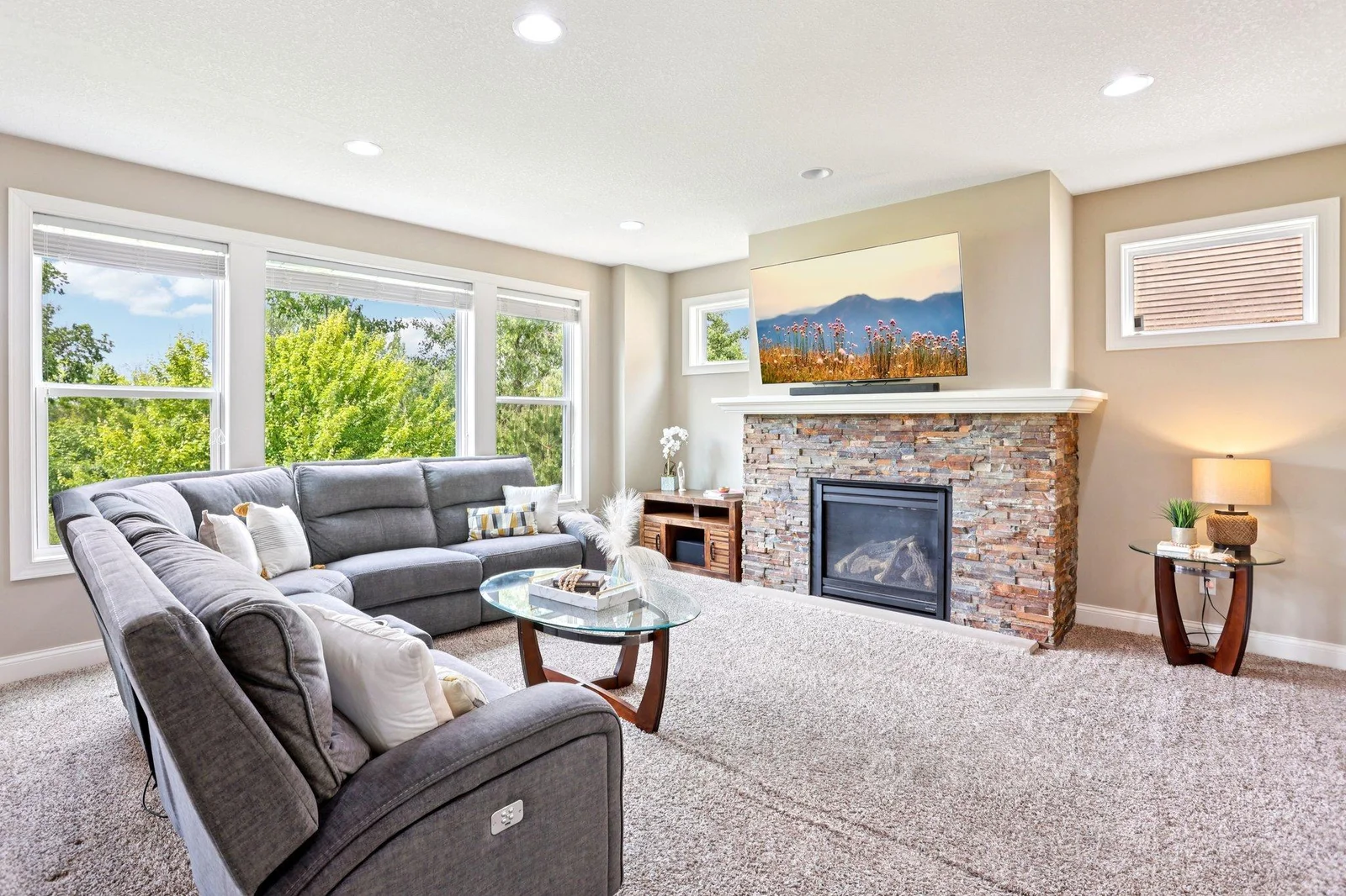 The living room offers a warm and inviting atmosphere, featuring lush carpeting and fireplace that adds comfort.