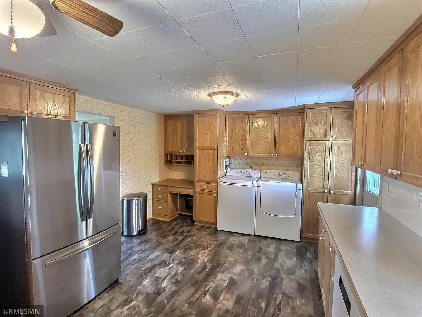 Kitchen area has a built in desk, plenty of cabinet storage with pull out cabinets and access to the deck.