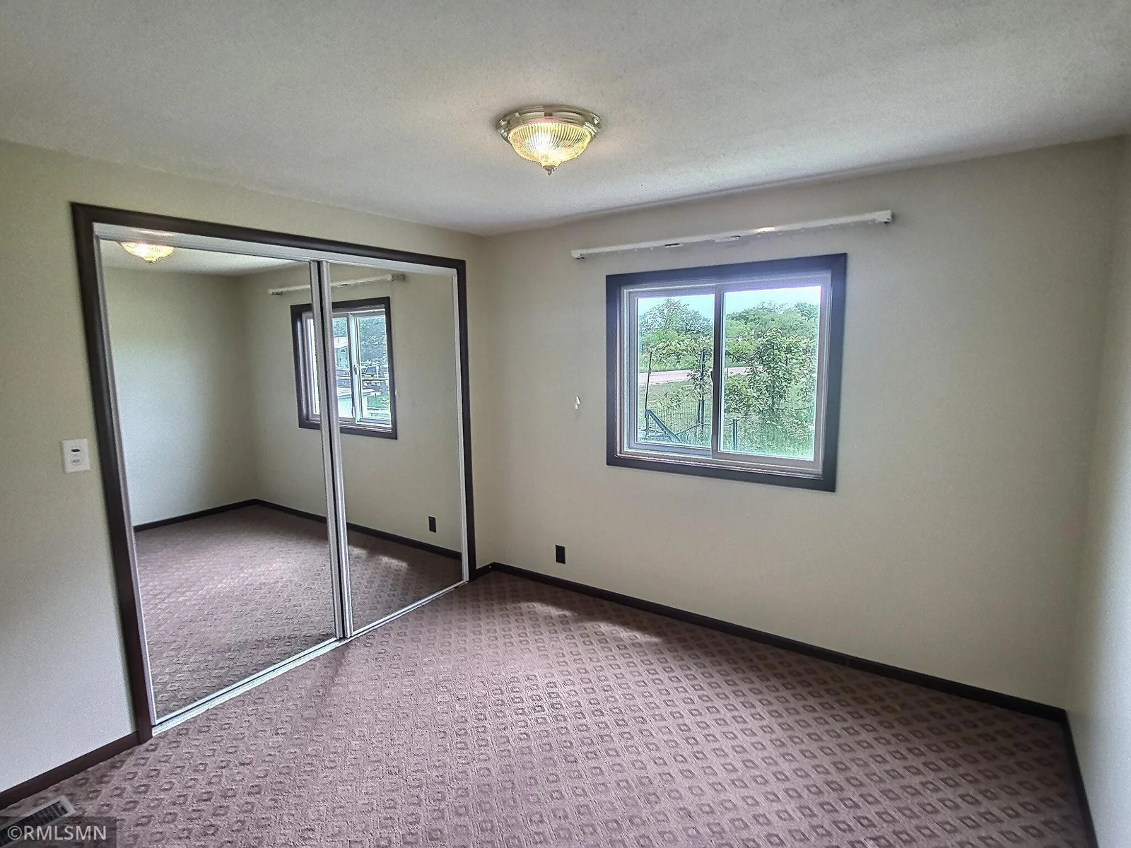 The 2nd bedroom has a large closet and good views of the garden.