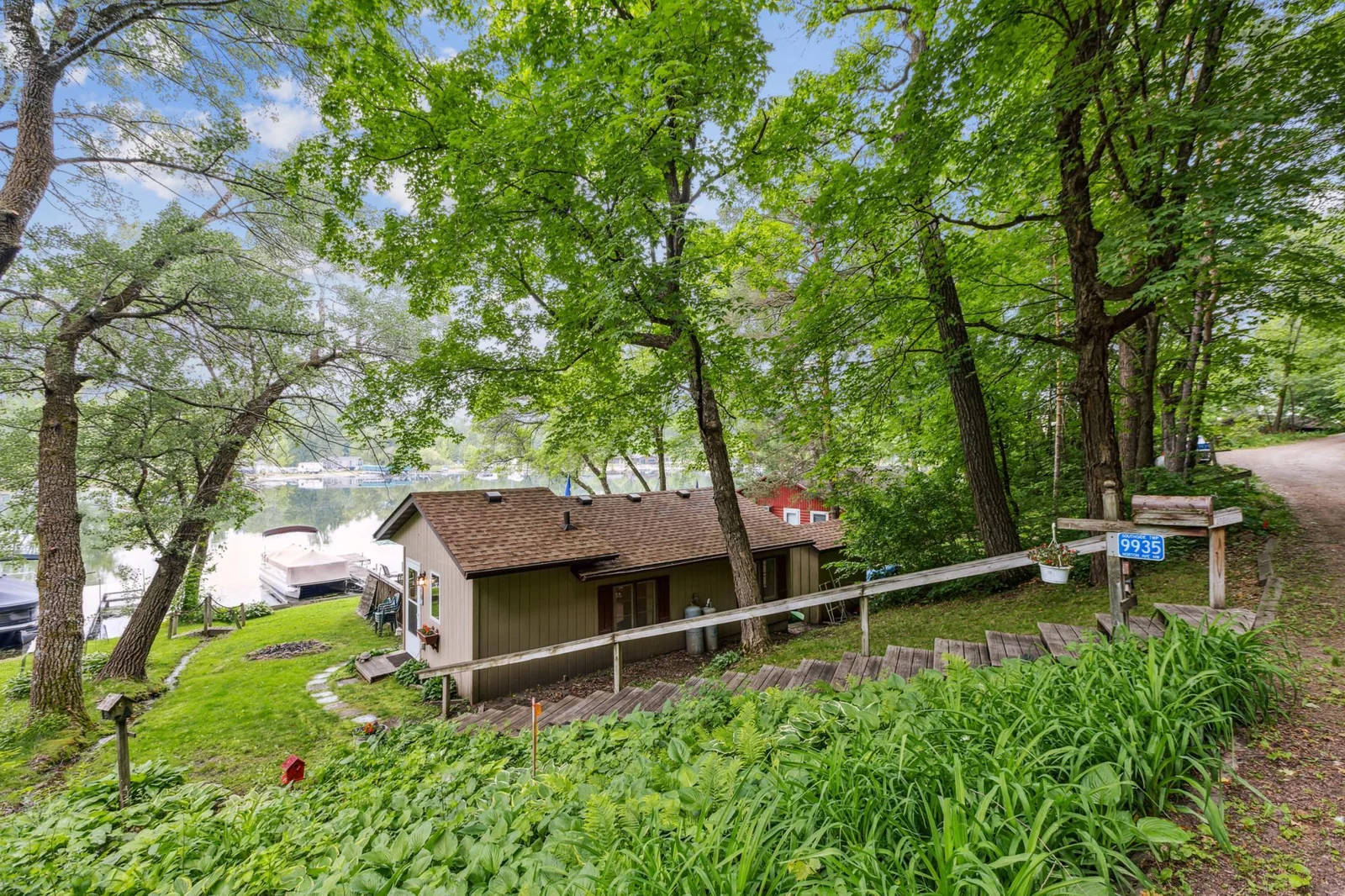 A view from the road overlooks the property. Relax fishing right off the dock or just relaxing. This lake front retreat is the perfect place to relax.