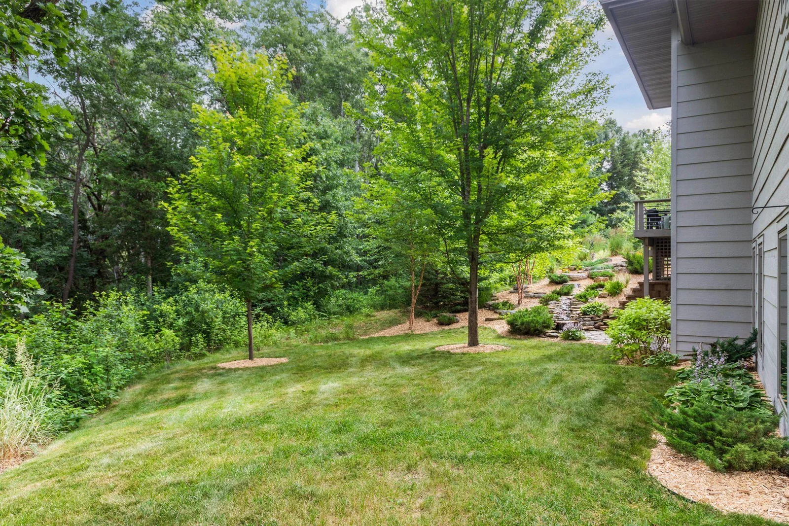 Surrounded by mature trees and vibrant greenery, the private backyard feels like a hidden retreat, peaceful and secluded.