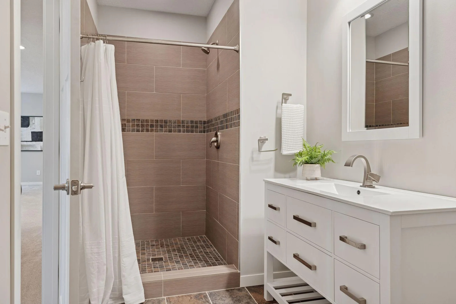 Clean, modern finishes continue in the lower level bathroom.