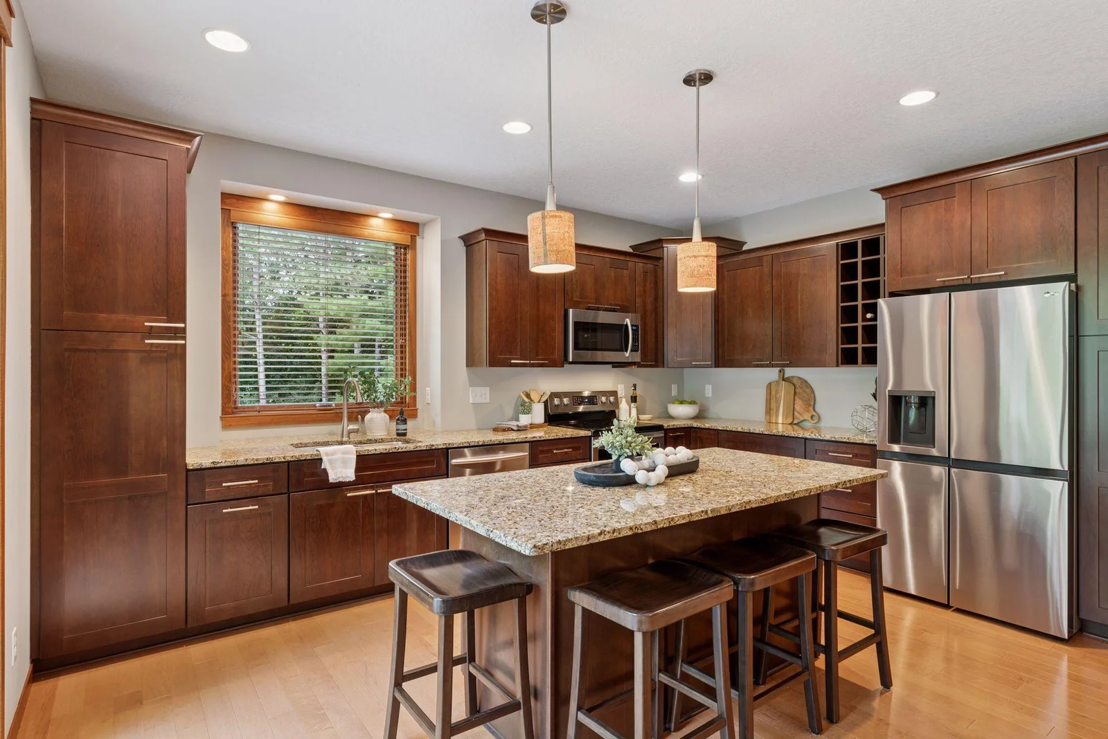 The oversized kitchen island offers plenty of prep space, seating, and style.