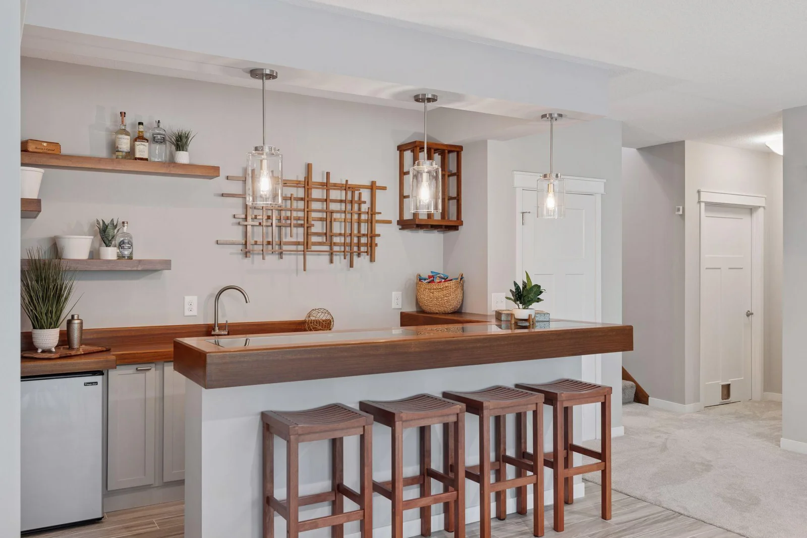 The custom wet bar features a shadow box island top, ready to showcase your favorite keepsakes.