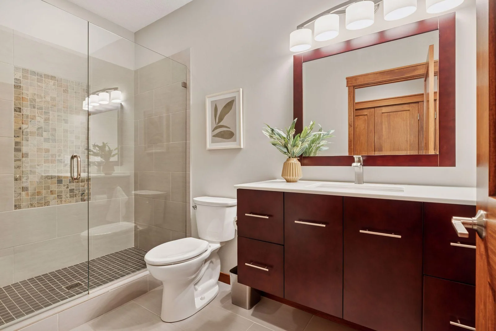 The main floor ¾ bathroom features stunning tile work and upscale finishes.