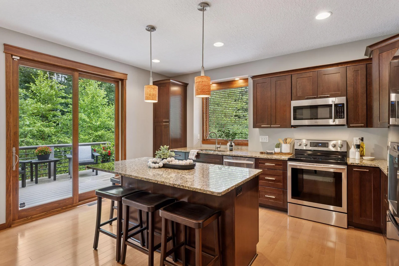 The kitchen shines with stainless steel appliances, a large island, and designer touches.