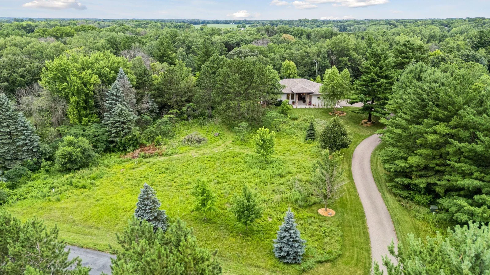 Another aerial perspective showcasing the mature trees and serene setting.