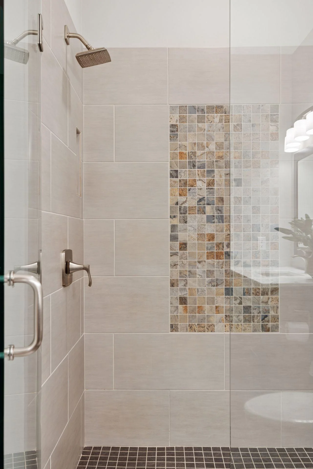 Beautiful tilework and glass details make this bathroom feel like a spa.
