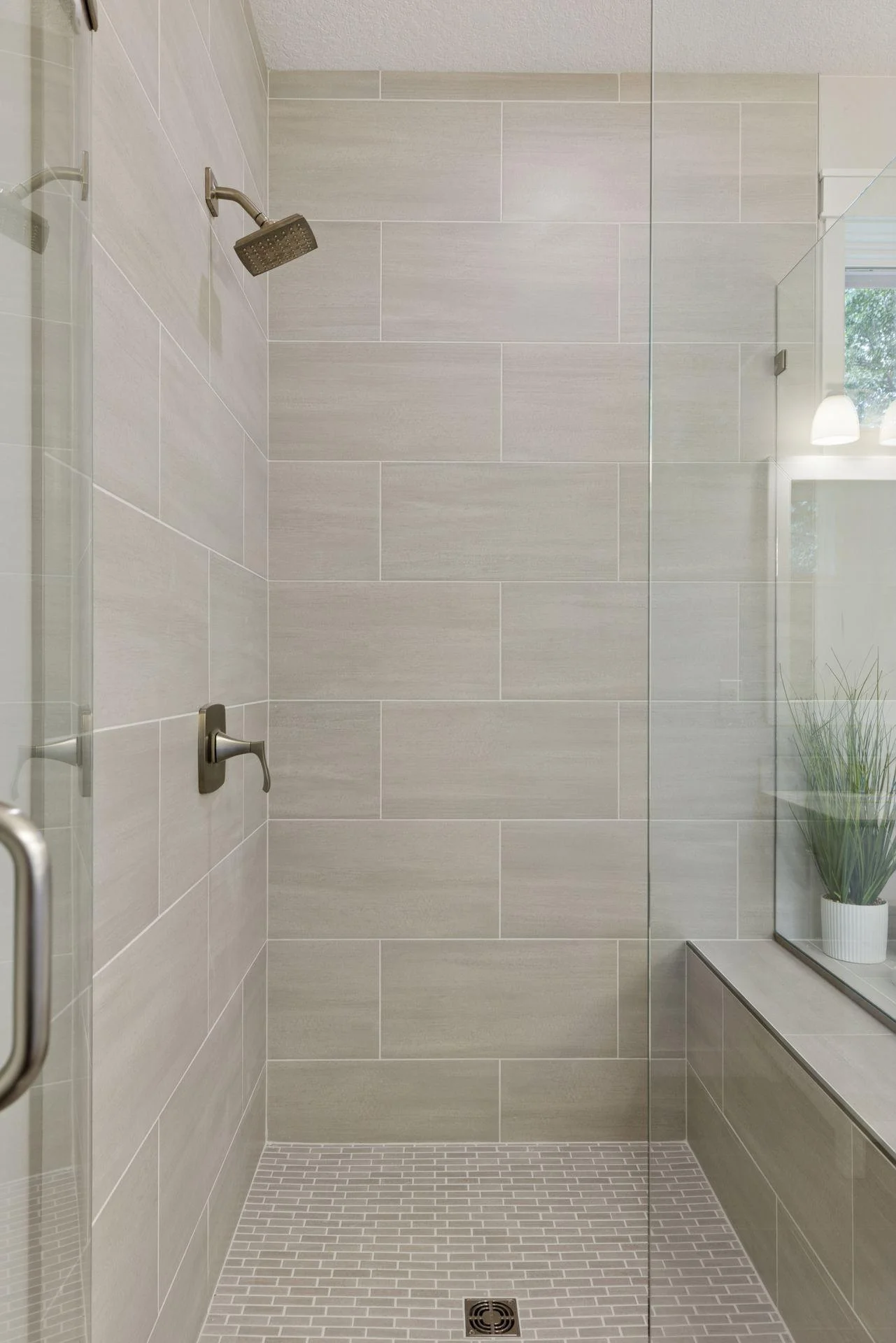 The newly tiled, glass-surround shower is as beautiful as it is functional.