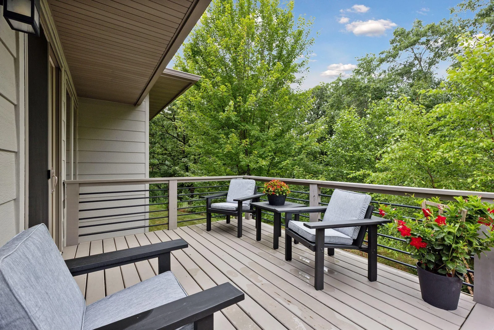The deck just off the kitchen offers seamless indoor-outdoor living and stunning backyard views.